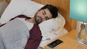 Download Free Video Stock Sleeping Man Is Awakened By His Cell Phone Alarm Live Wallpaper