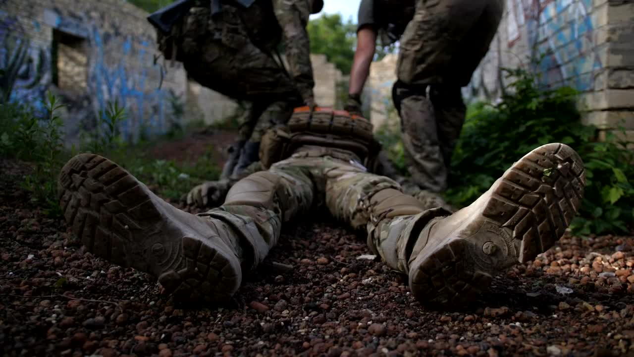 Download Free Video Stock Soldiers Drag A Wounded Man Live Wallpaper