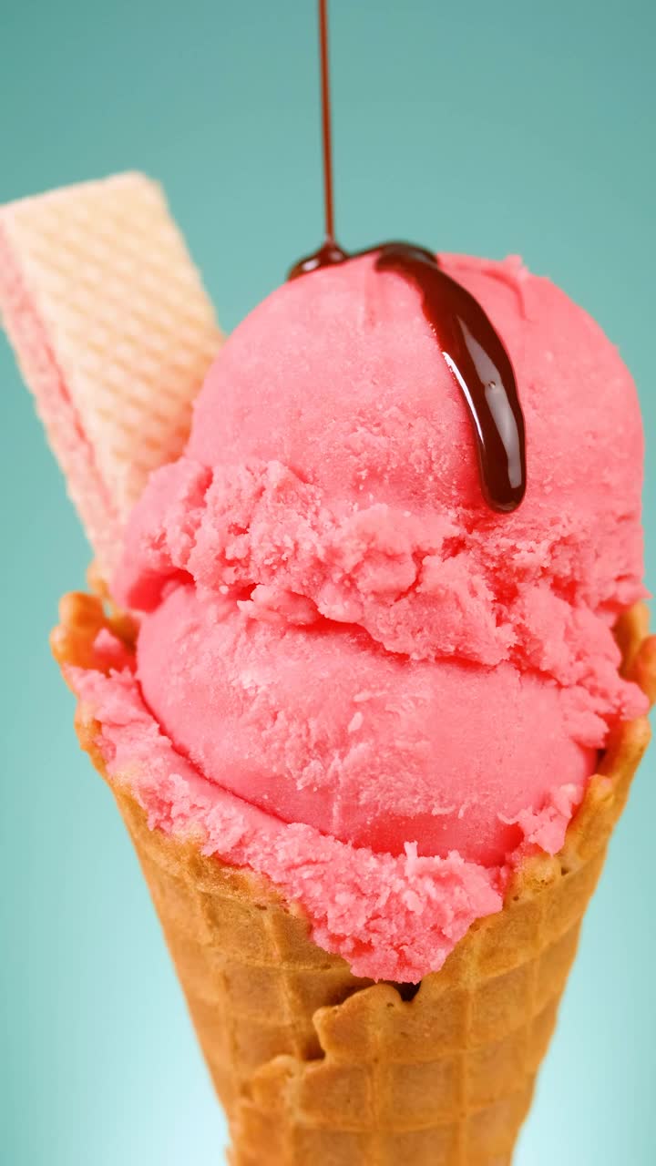 Download Free Video Stock Strawberry Ice Cream Cone With Chocolate Syrup On A Blue Live Wallpaper