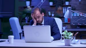 Download Free Video Stock Stressed Businessman Rubs Eyes While Working On Laptop Live Wallpaper