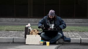 Download Free Video Stock super excited homeless man with a laptop Live Wallpaper