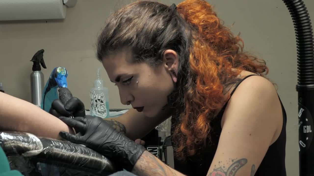 Download Free Video Stock tattoo artist working on a customer Live Wallpaper