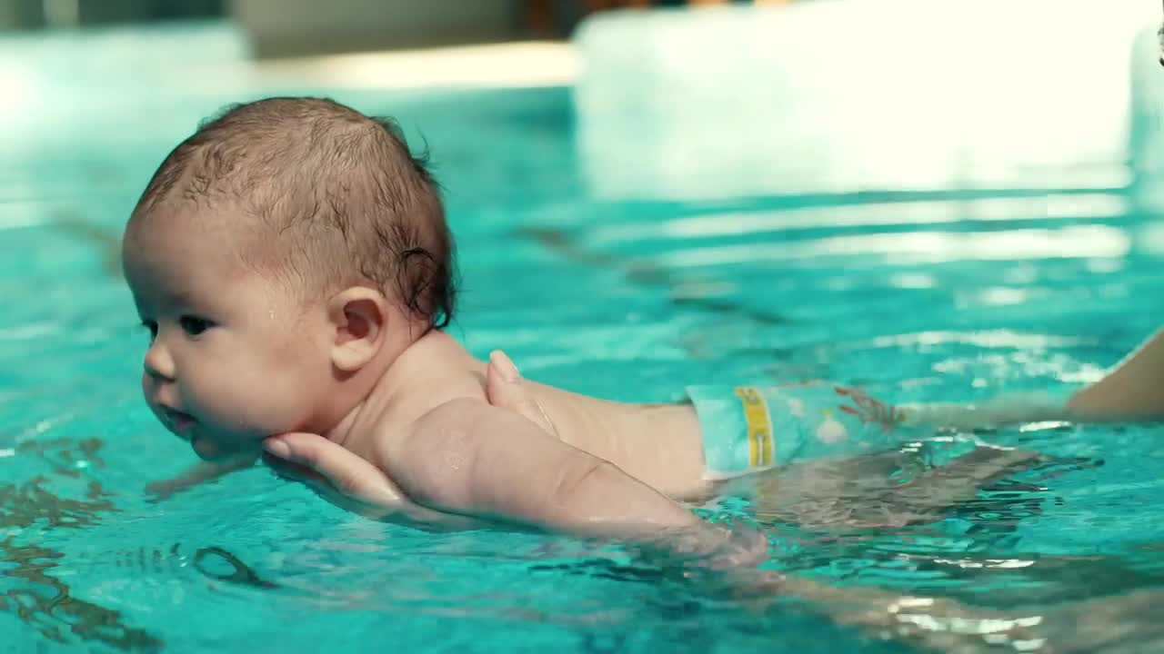 Download Free Video Stock teaching a baby to swim in the pool Live Wallpaper