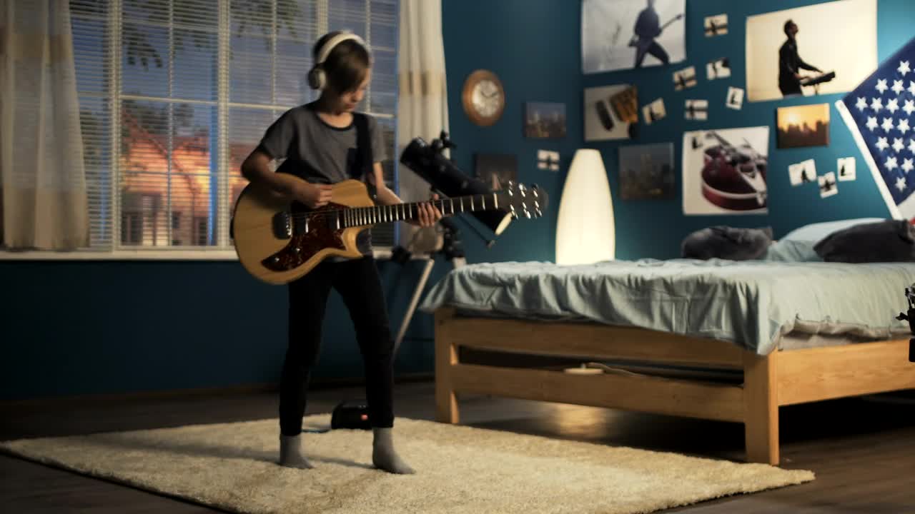 Download Free Video Stock teen boy playing the guitar on the bedroom Live Wallpaper