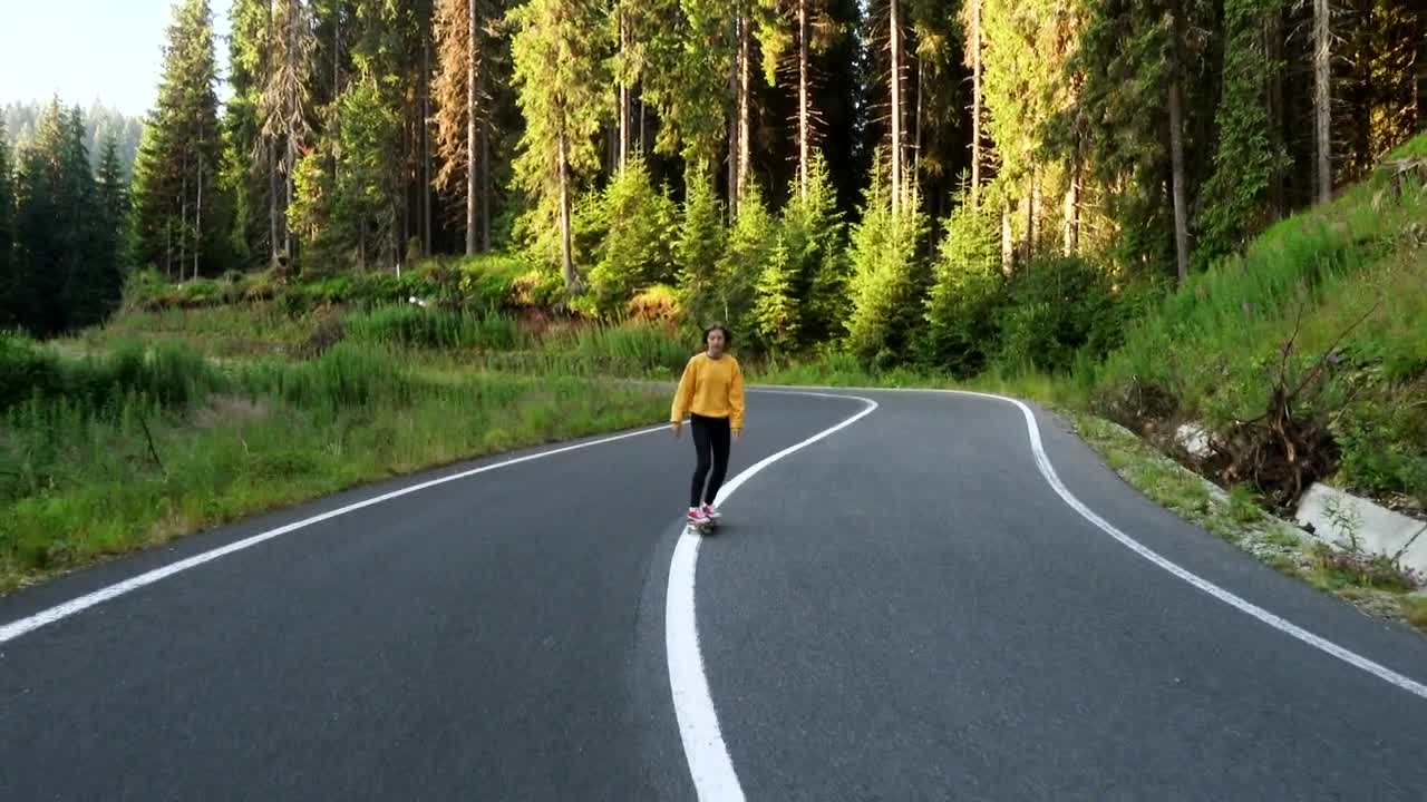 Download Free Video Stock teen woman on a skateboard on the road Live Wallpaper