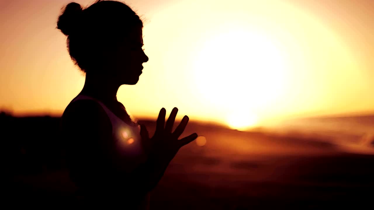 Download Free Video Stock the silhouette of a woman at sunrise Live Wallpaper