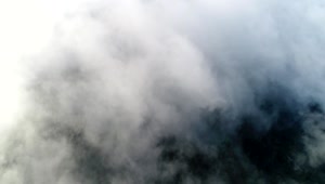 Download Free Video Stock thick clouds over a mountain Live Wallpaper