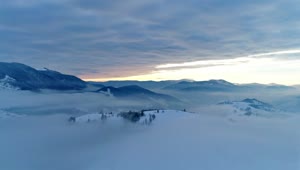 Download Free Video Stock thick layer of clouds over snowy mountains Live Wallpaper