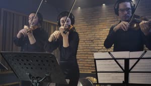 Download Free Video Stock three expert violinists playing together in a studio Live Wallpaper