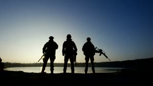 Download Free Video Stock three soldier silhouettes posign with guns Live Wallpaper