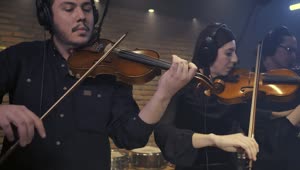 Download Free Video Stock three violinists playing together in a recording studio 41690Live Wallpaper