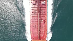 Download Free Video Stock top aerial shot of a cargo ship sailing in sea Live Wallpaper