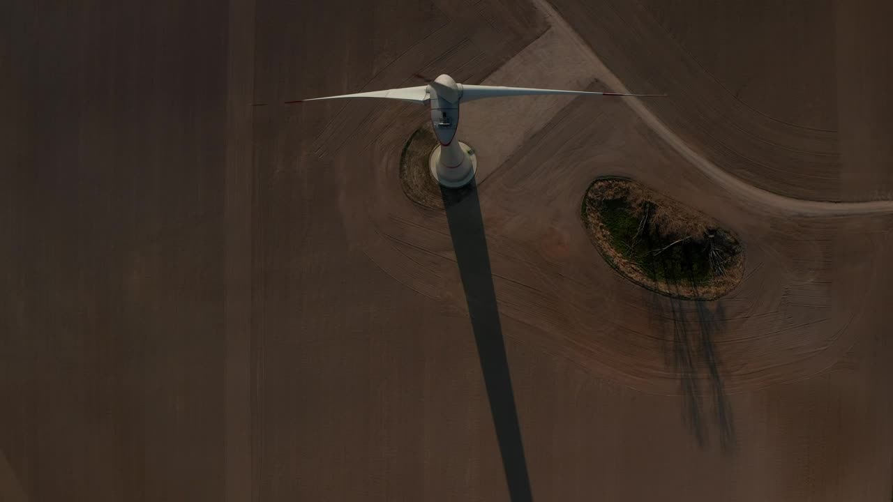 Download Free Video Stock top aerial shot of a wind turbine spinning Live Wallpaper