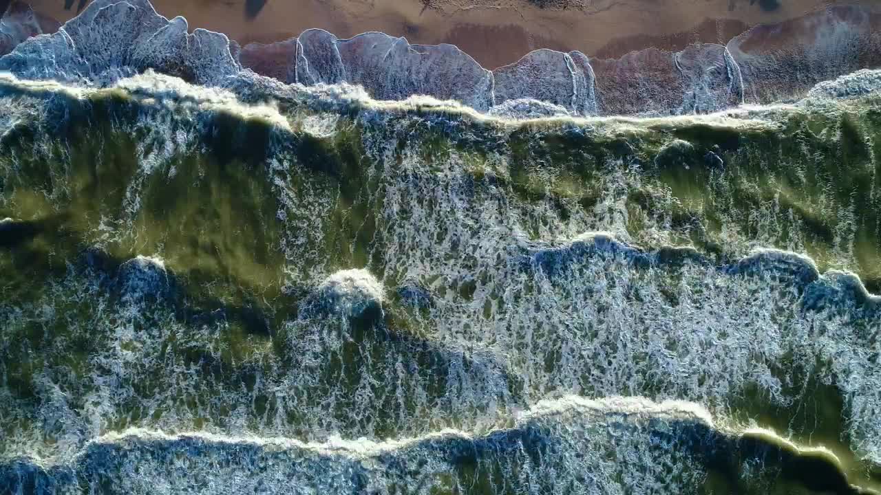 Download Free Video Stock top aerial view of the sea waves reaching a beach Live Wallpaper