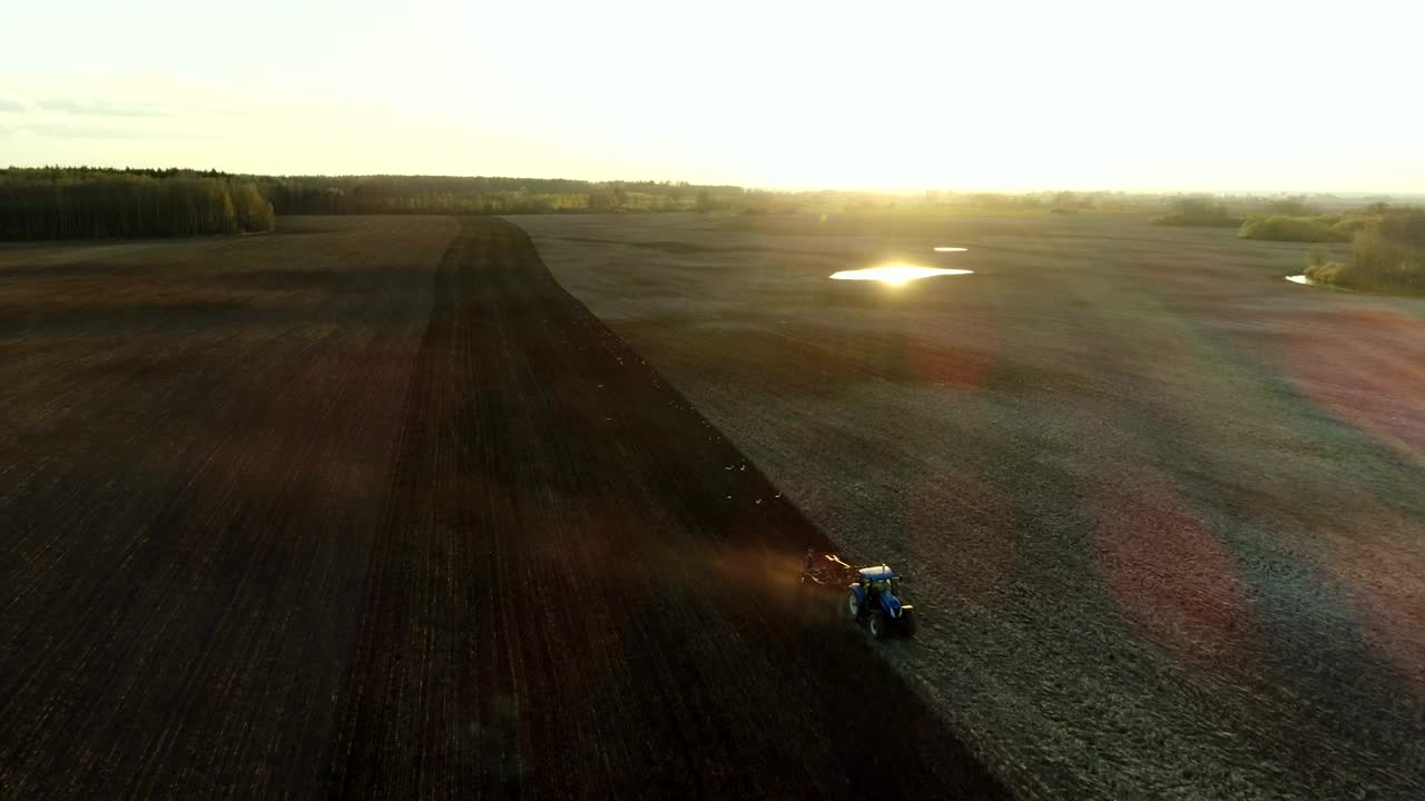 Download Free Video Stock tractor working in the field with sunbeams Live Wallpaper