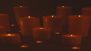 Download Free Stock Video Very Large And Very Small Candles Lit In The Dark Live Wallpaper