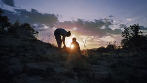Download Free Stock Video Two Mountaineers Putting Away Their Things During The Sunset Live Wallpaper