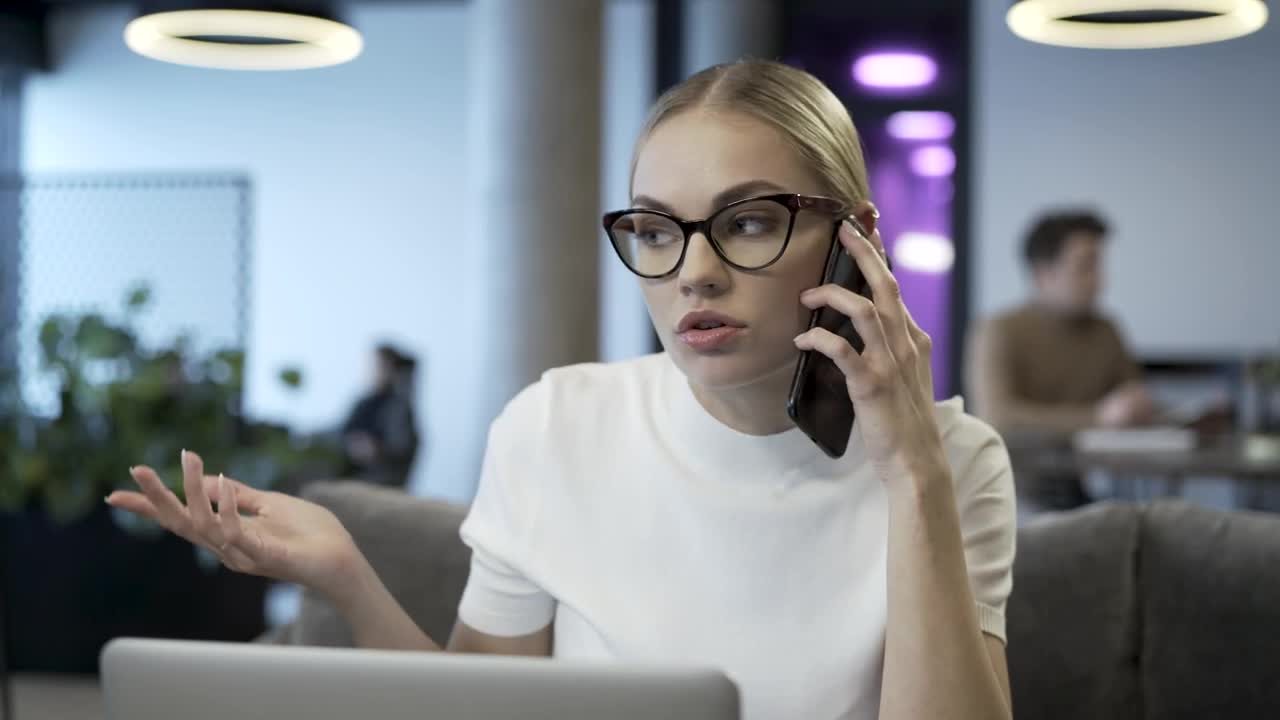 Download Free Stock Video Young Woman With Glasses Talking On The Phone Live Wallpaper