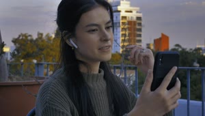 Download Free Stock Video Young Woman On A Terrace Having A Video Call Live Wallpaper