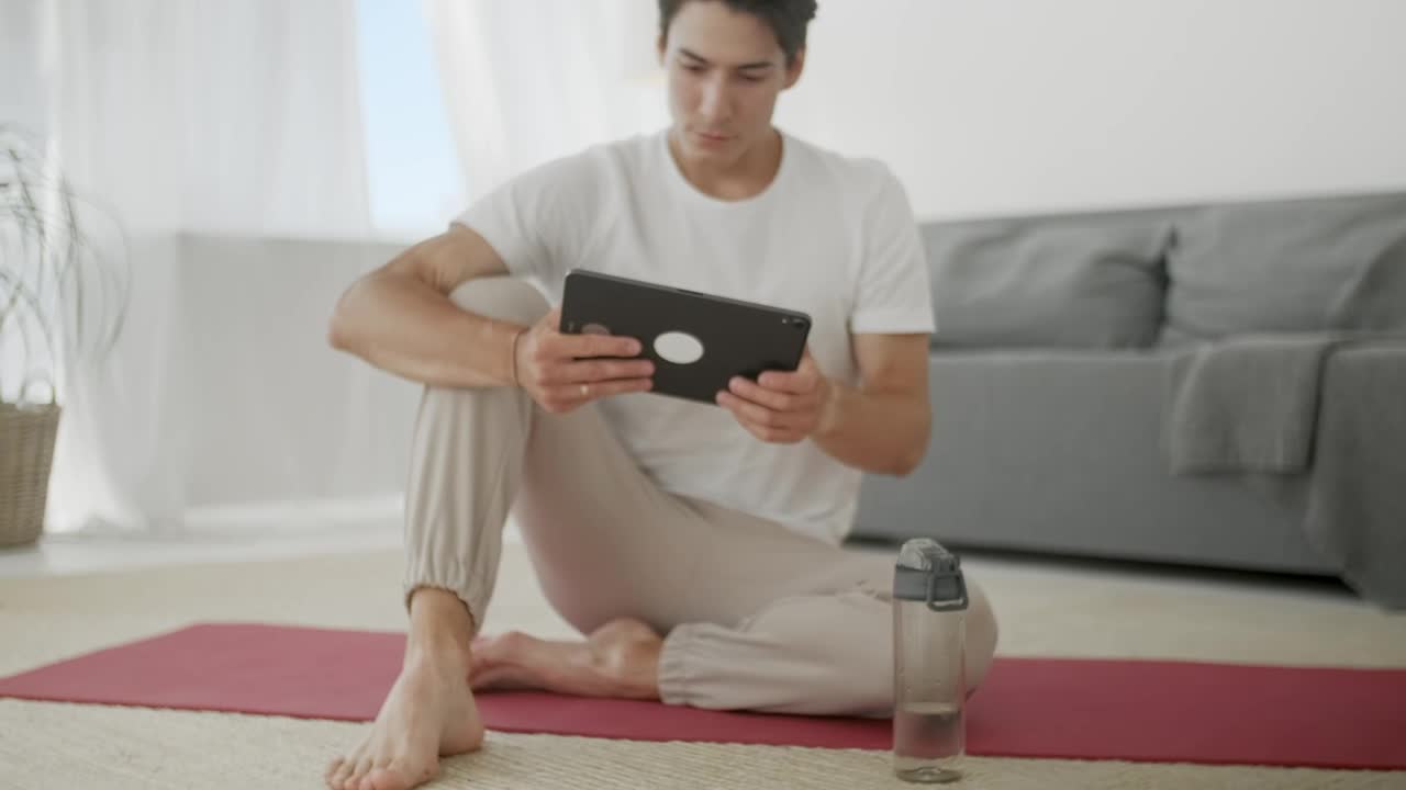 Download Free Stock Video Young Man Watching Yoga Videos For Practice Live Wallpaper