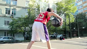 Download Free Stock Video Young Man Practicing Basketball On A Court Live Wallpaper