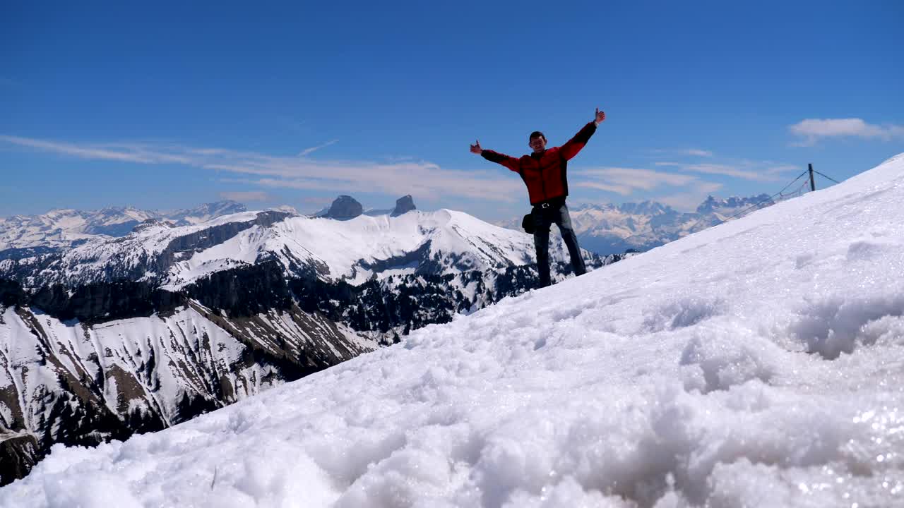 Download Free Stock Video Young Man On The Top Of A Snowy Mountain Live Wallpaper