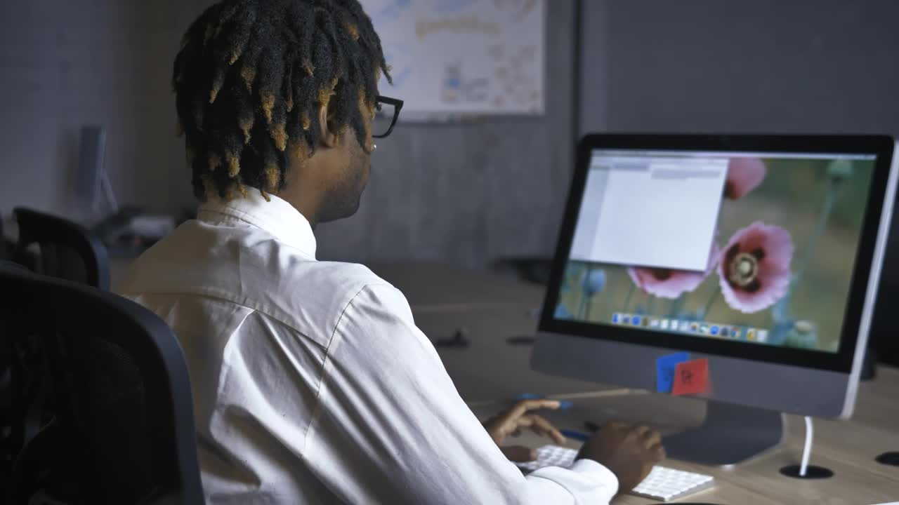 Download Free Stock Video Young Man In Front Of The Computer In An Office Live Wallpaper