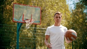 Download Free Stock Video Young Man Dribbling A Basketball Facing The Lens Live Wallpaper