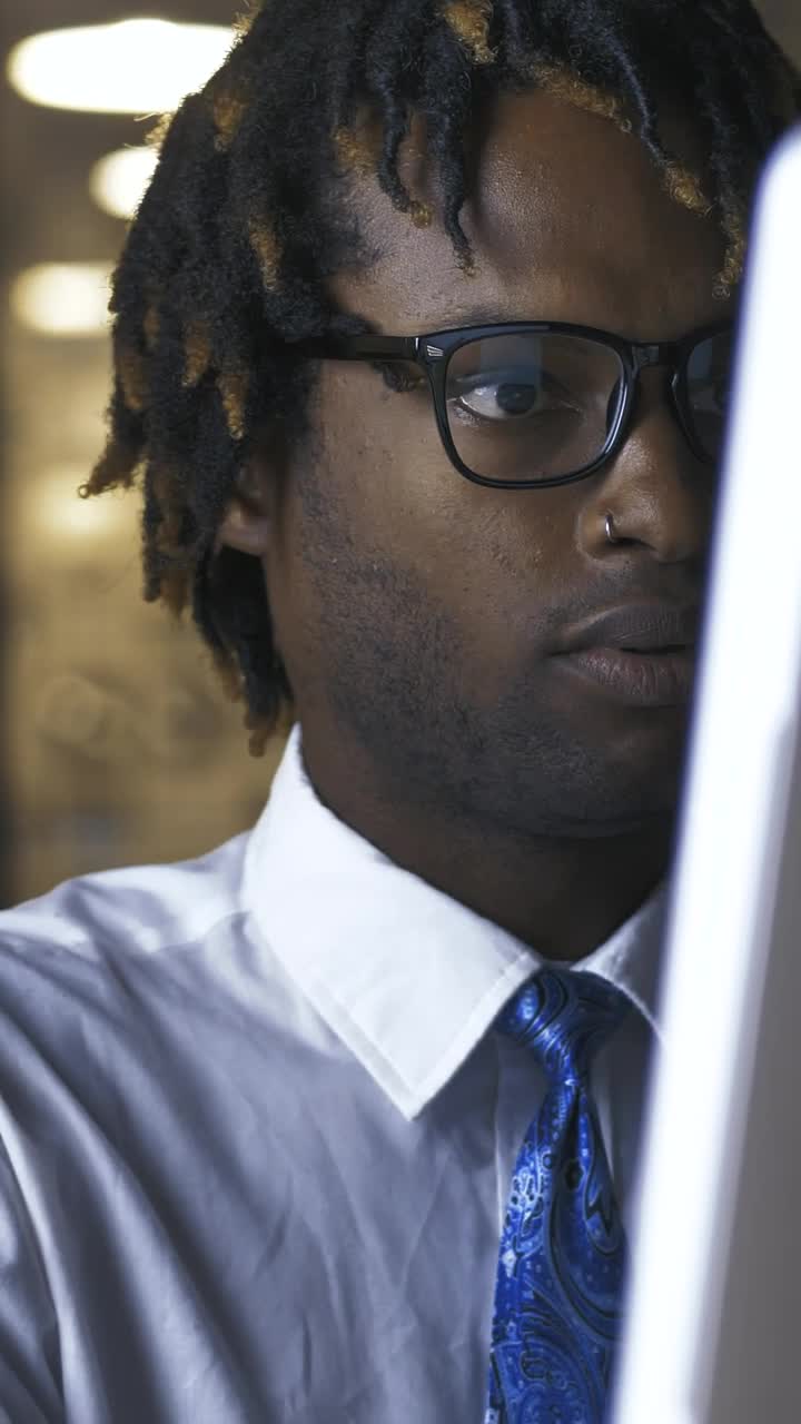 Download Free Stock Video Young Man Adjusting His Glasses While Working On Computer Live Wallpaper