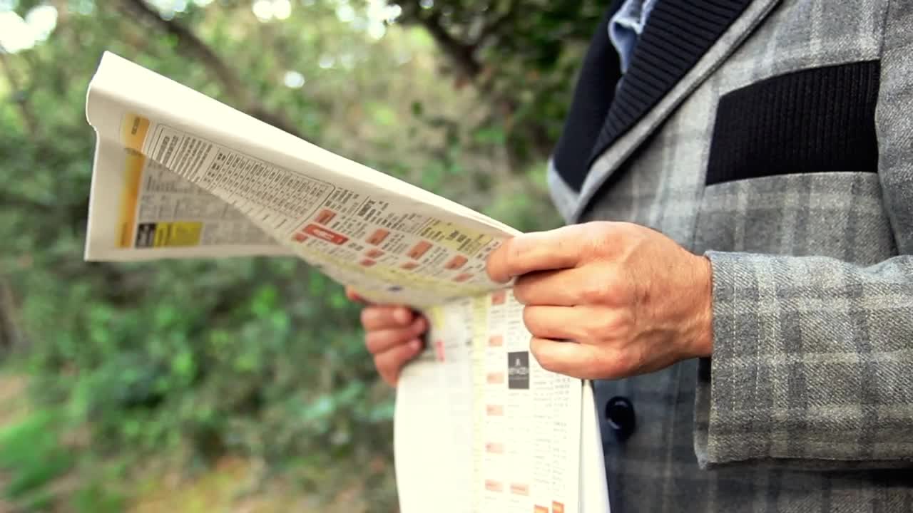 Download Free Stock Video Young Adult Reading The Newspaper Live Wallpaper