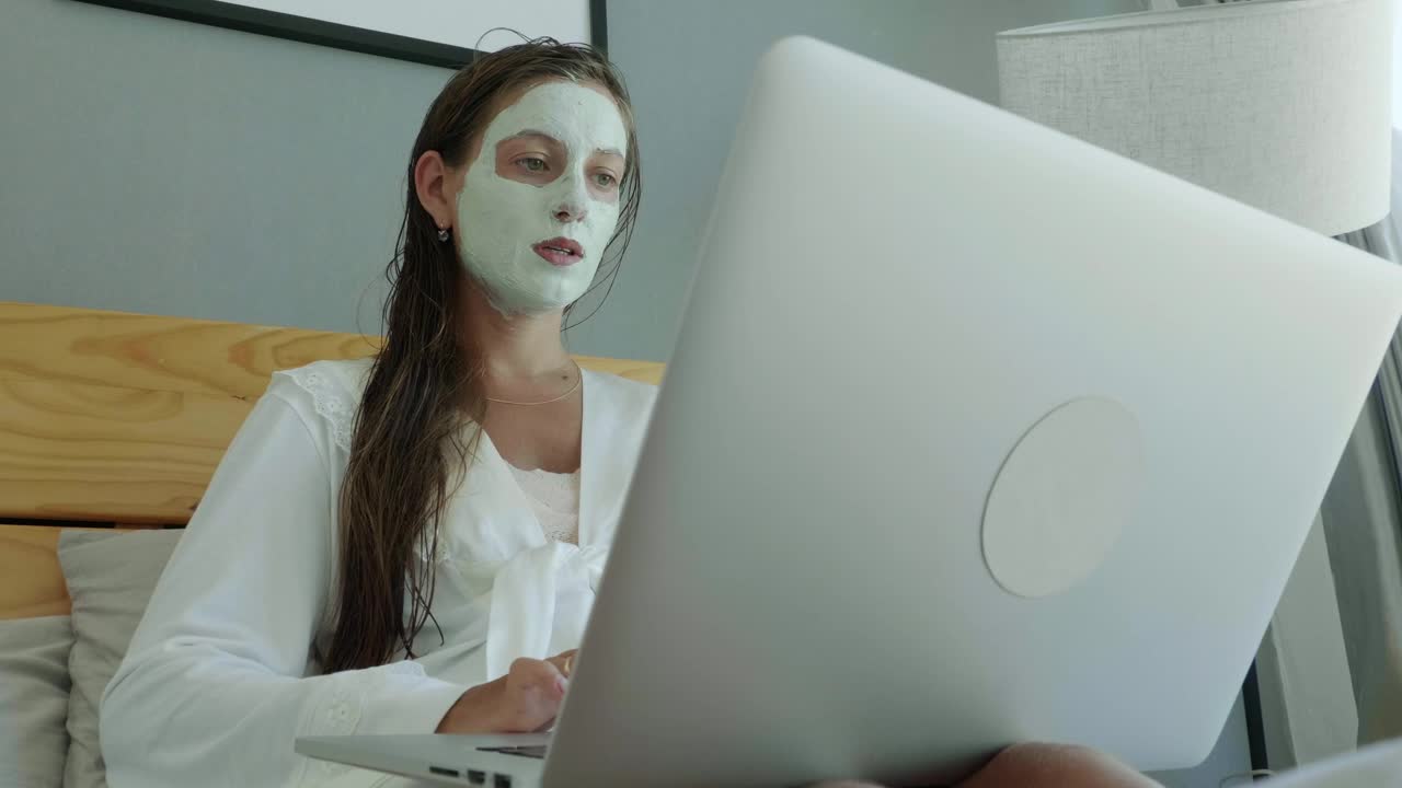 Download Free Stock Video Woman Working On The Bed With A Beauty Face Mask Live Wallpaper