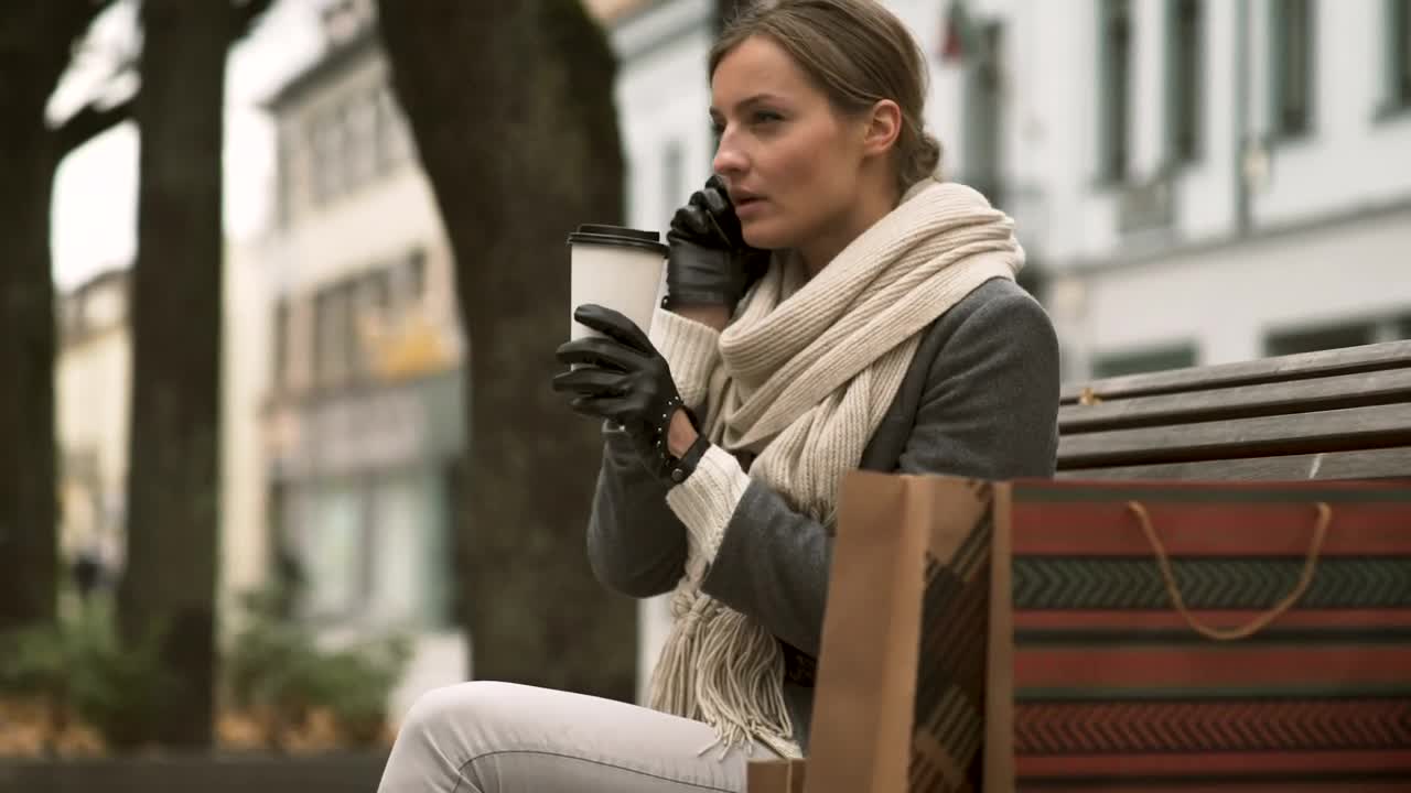 Download Free Stock Video Woman Talking On The Phone On A Public Bench Live Wallpaper