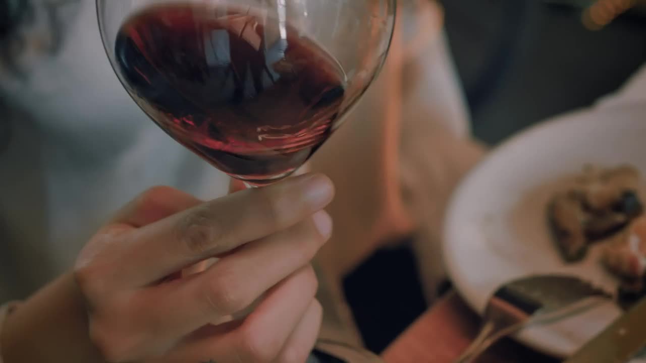 Download Free Stock Video Woman Shaking A Glass Of Wine Before Drinking From It Live Wallpaper