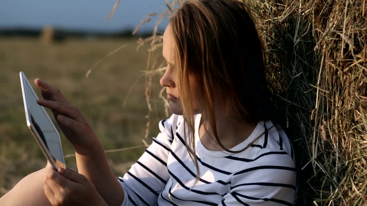 Download Free Stock Video Woman Resting In A Field With Her Tablet Live Wallpaper