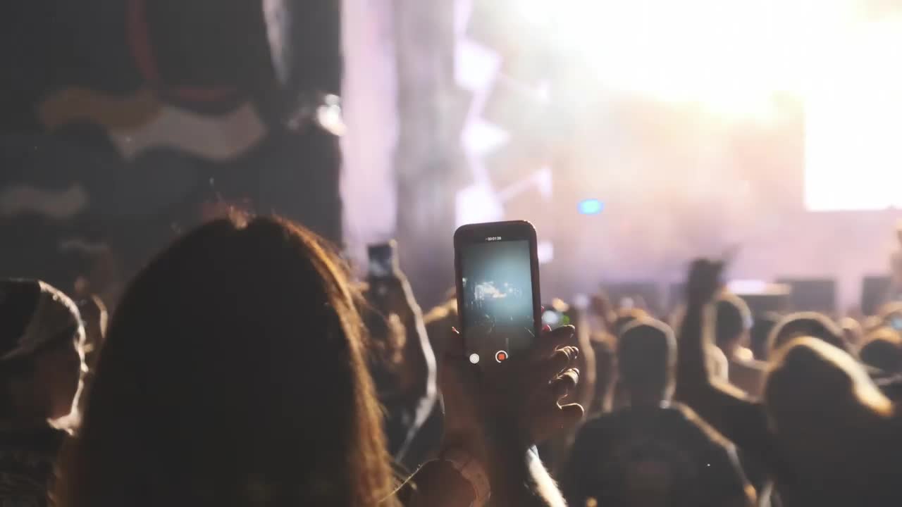 Download Free Stock Video Woman Recording A Concert With Her Smartphone Live Wallpaper