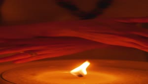 Download Free Stock Video Woman Passing Her Hands Near The Flame Of A Candle Live Wallpaper