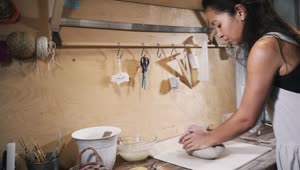 Download Free Stock Video Woman Kneads Clay In The Workshop Live Wallpaper