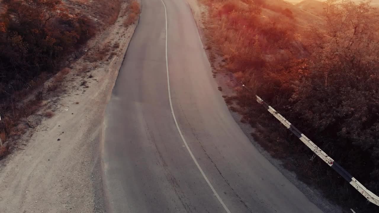 Download Free Stock Video Woman Jogging Down A Road Seen From The Air Live Wallpaper