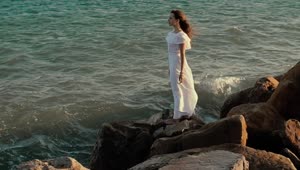 Download Free Stock Video Woman In White Dress Looking Out To Sea Live Wallpaper