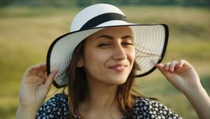 Download Free Stock Video Woman Holding Her Hat In A Meadow Live Wallpaper