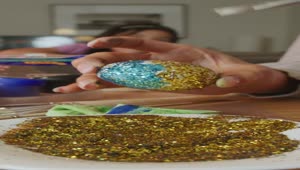 Download Free Stock Video Woman Gluing Glitter To An Easter Egg Live Wallpaper
