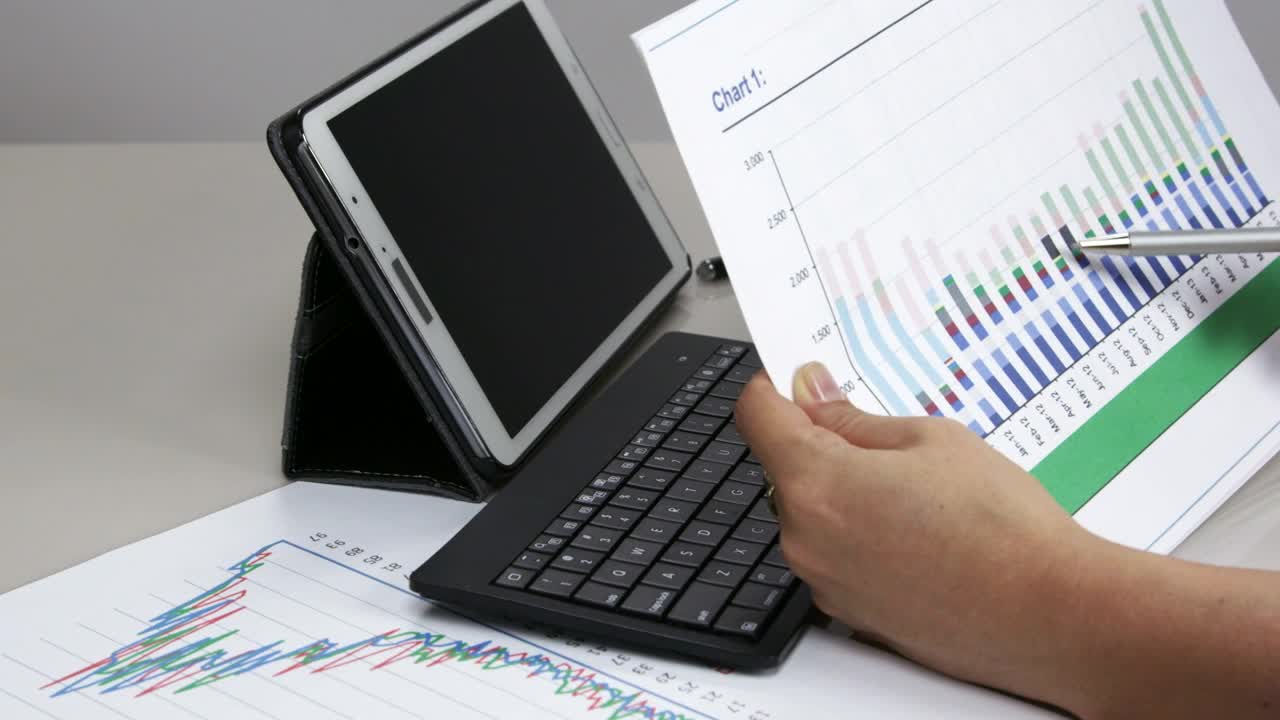 Download   Stock Footage Woman Checking A Graph At Work Live Wallpaper