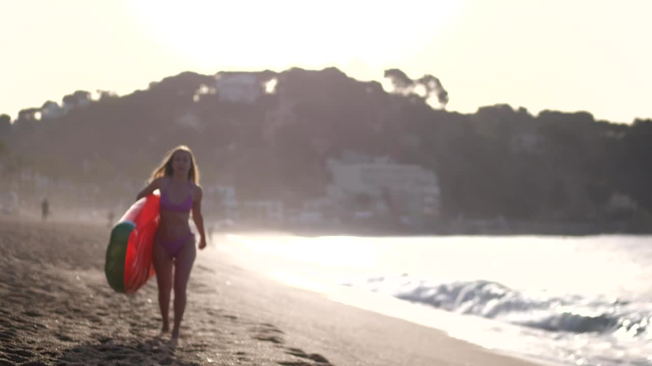 Download   Stock Footage Woman Carrying A Beach Inflatable Live Wallpaper