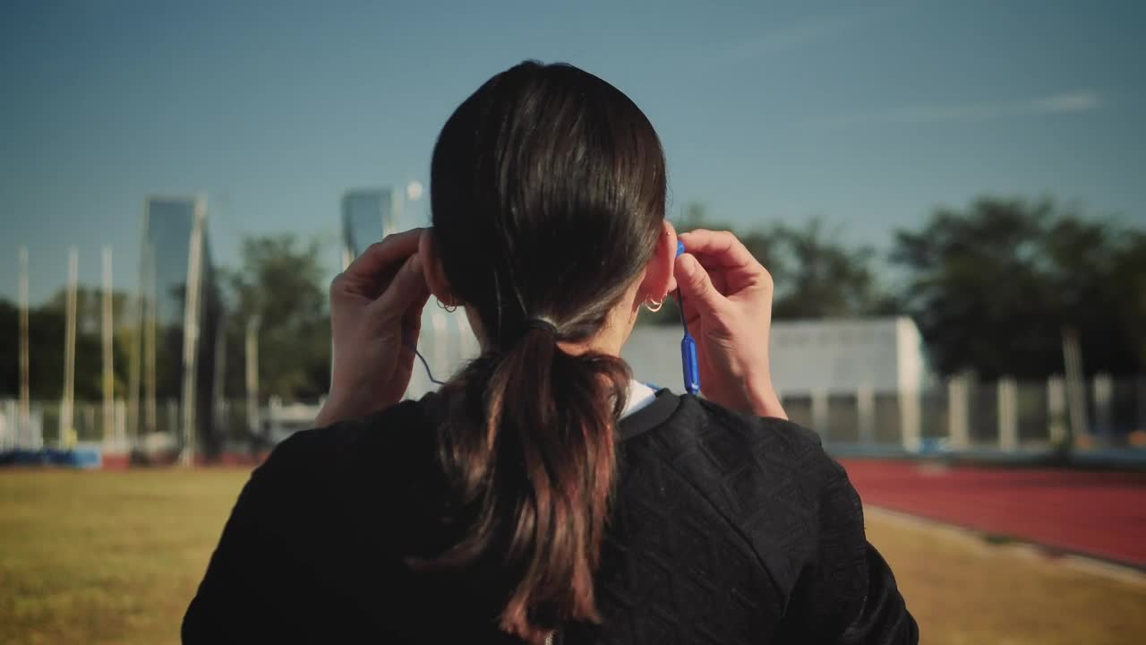 Download   Stock Footage Woman Adjusting Her Headphones To Start Running Live Wallpaper