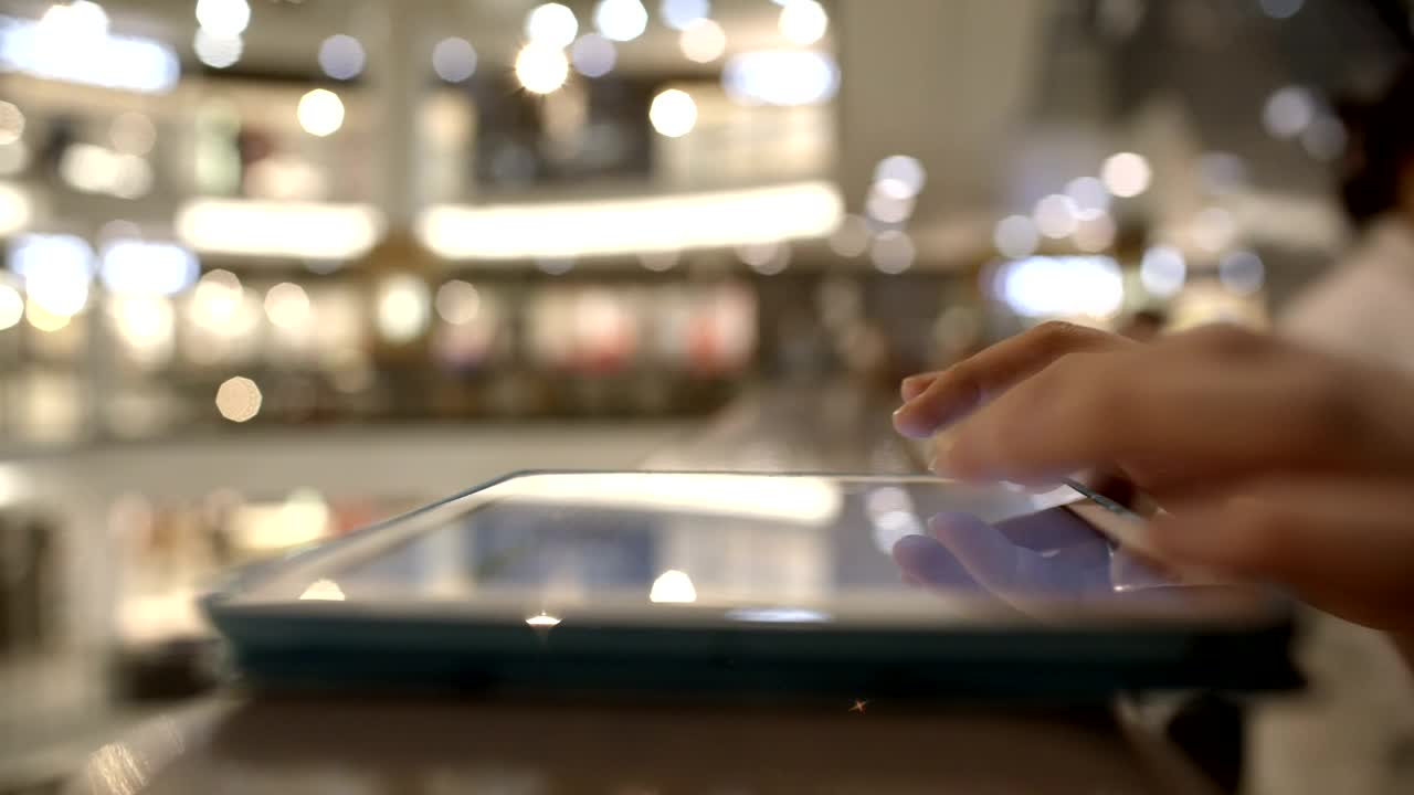 Download   Stock Footage Using A Tablet In A Mall Live Wallpaper