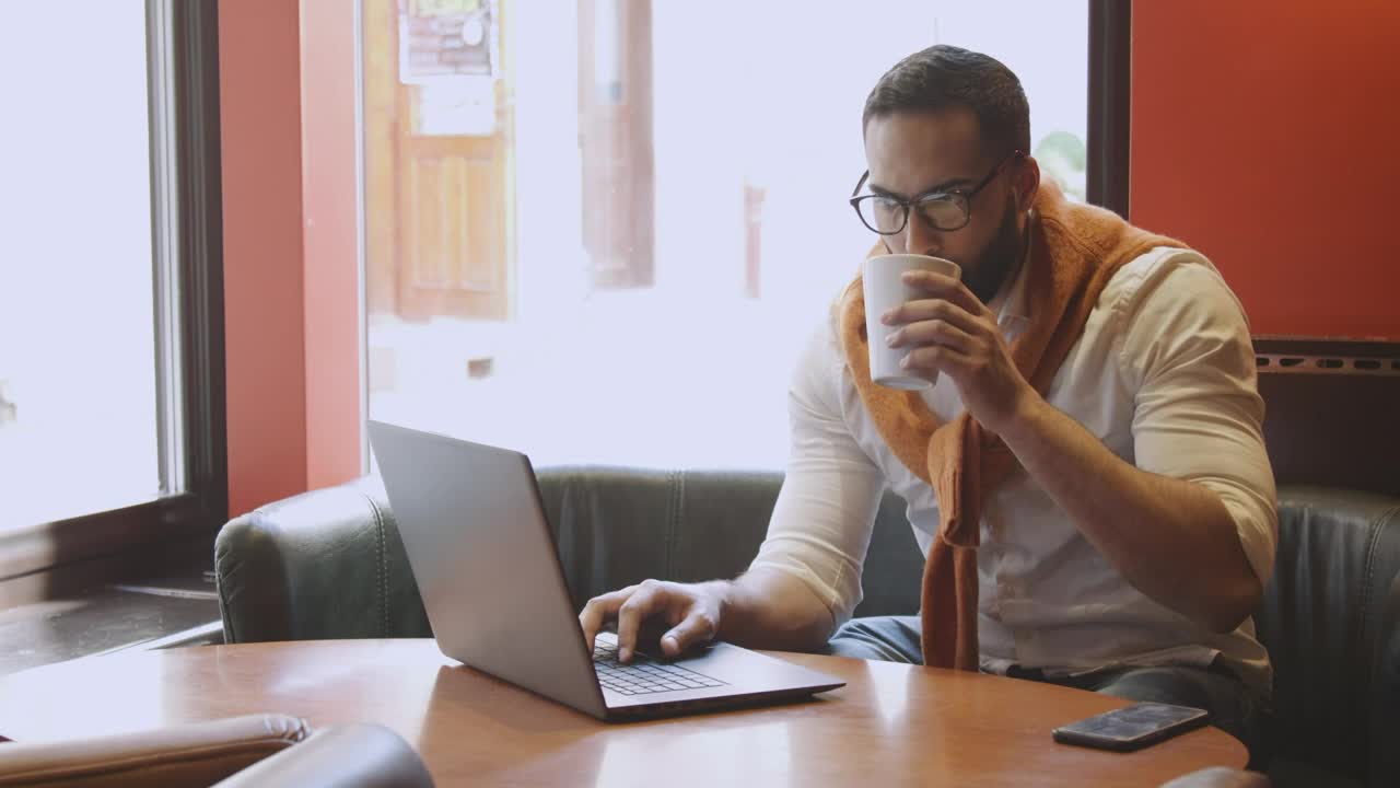 Download   Stock Footage Urban Man Sips Coffee While Working In Cafe Live Wallpaper