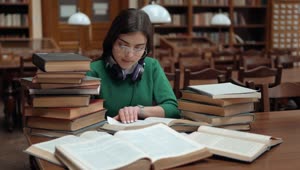 Download   Stock Footage University Student Researching With Books In Library Live Wallpaper