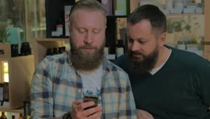 Download   Stock Footage Two Men With Beards Checking A Phone Live Wallpaper