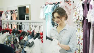 Download   Stock Footage Woman Choosing Clothes In A Store Live Wallpaper