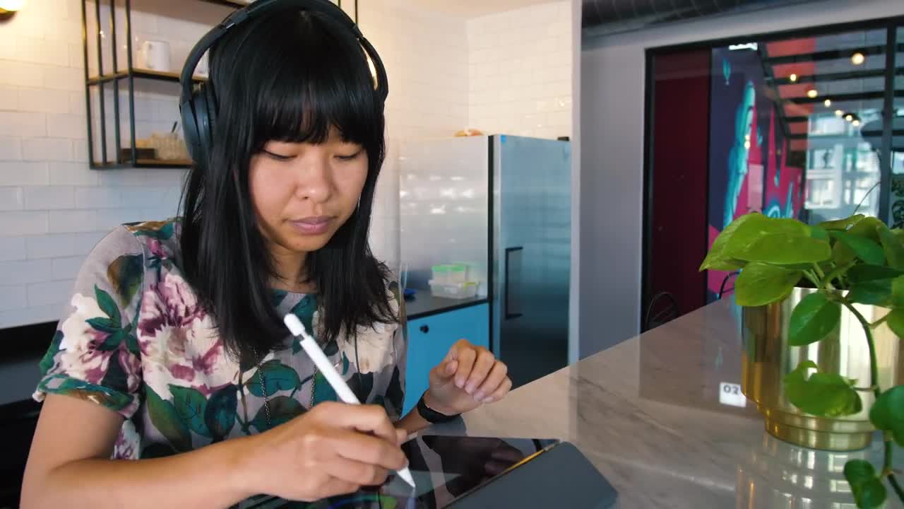 Download Stock Footage Young Woman Working On A Tablet In A Kitchen Live Wallpaper Free